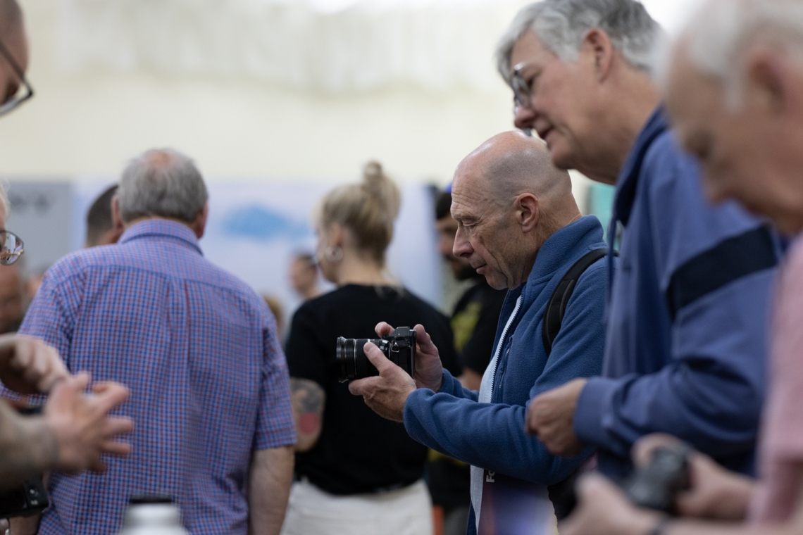 A buzzing crowd explores the latest cameras, lenses, and accessories from leading brands at Spring Shoot 2025.